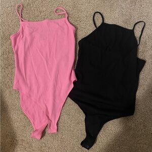 Two pink and black forever21 bodysuits